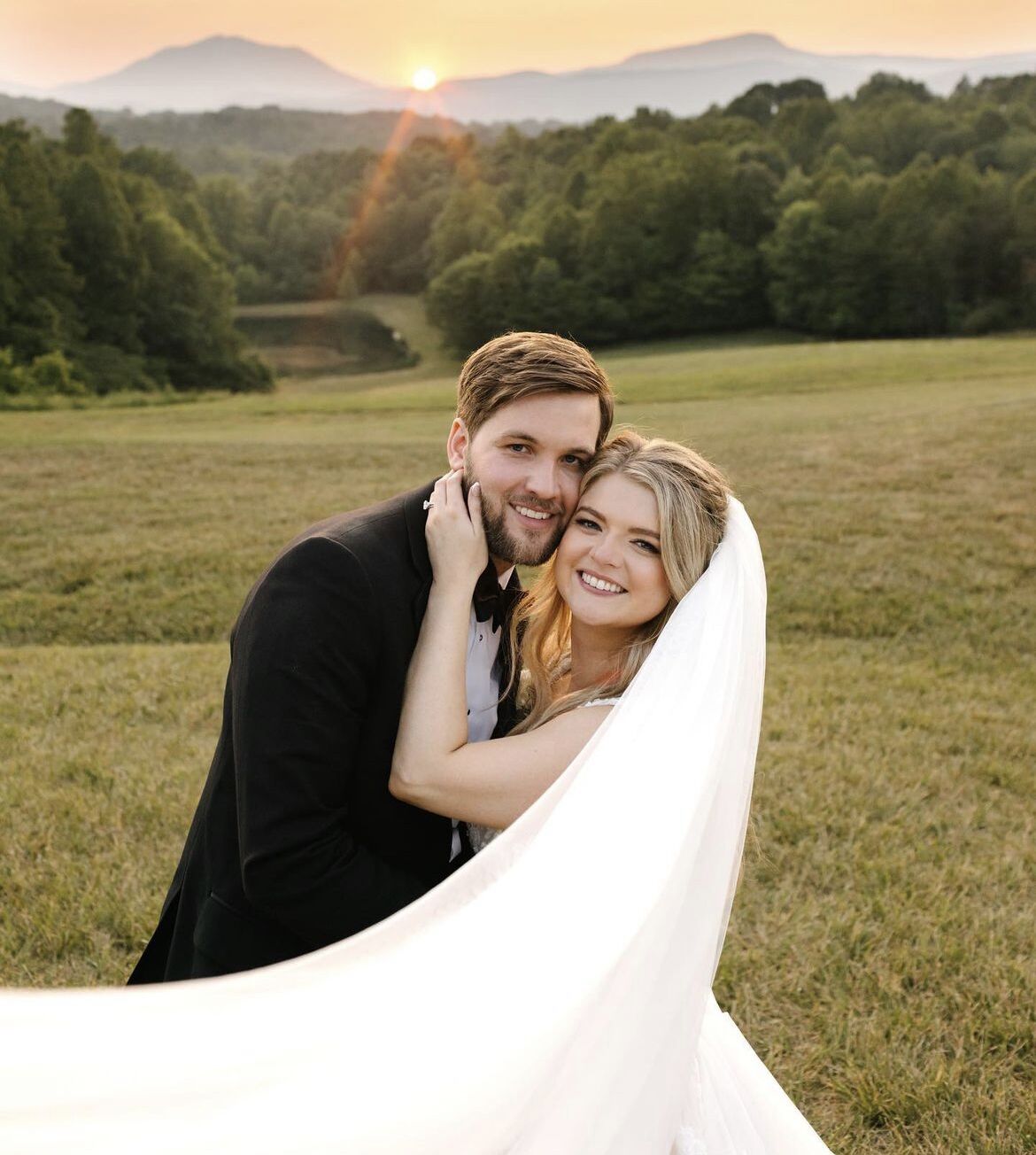Brittany and Adam Bloom standing together on their wedding day