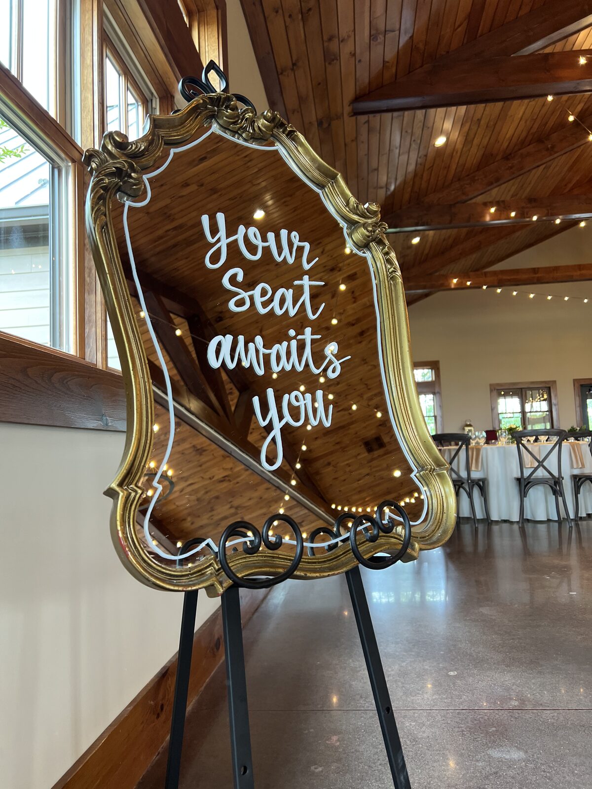 Bloom wedding mirror sign reading your seat awaits you