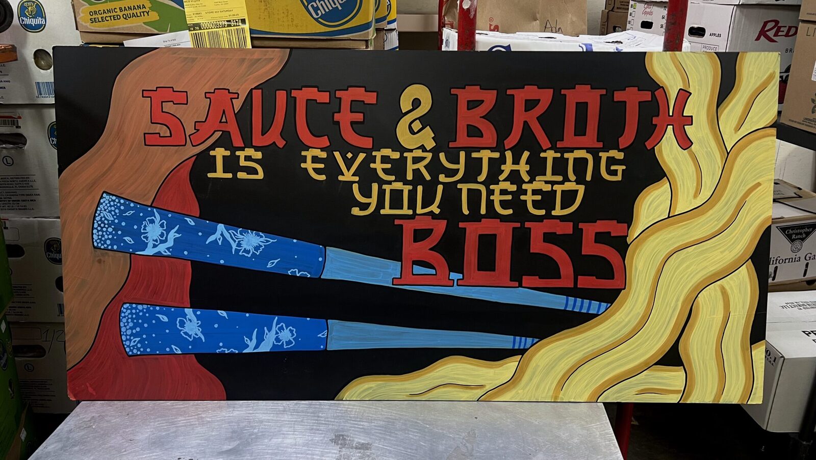Sauce and broth chalkboard display sign with painted lettering