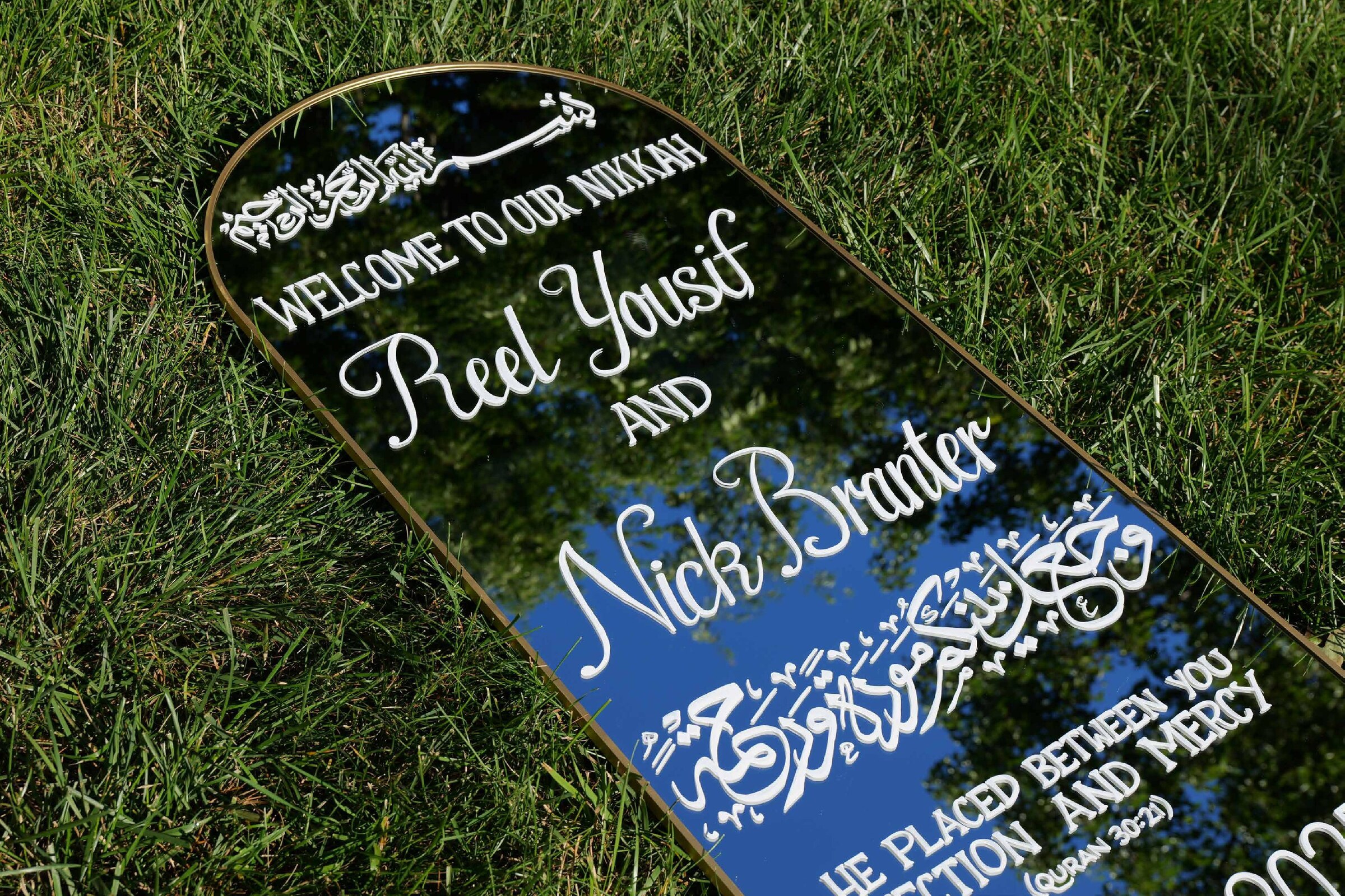 Close detail of hand-painted wedding lettering on reflective signage